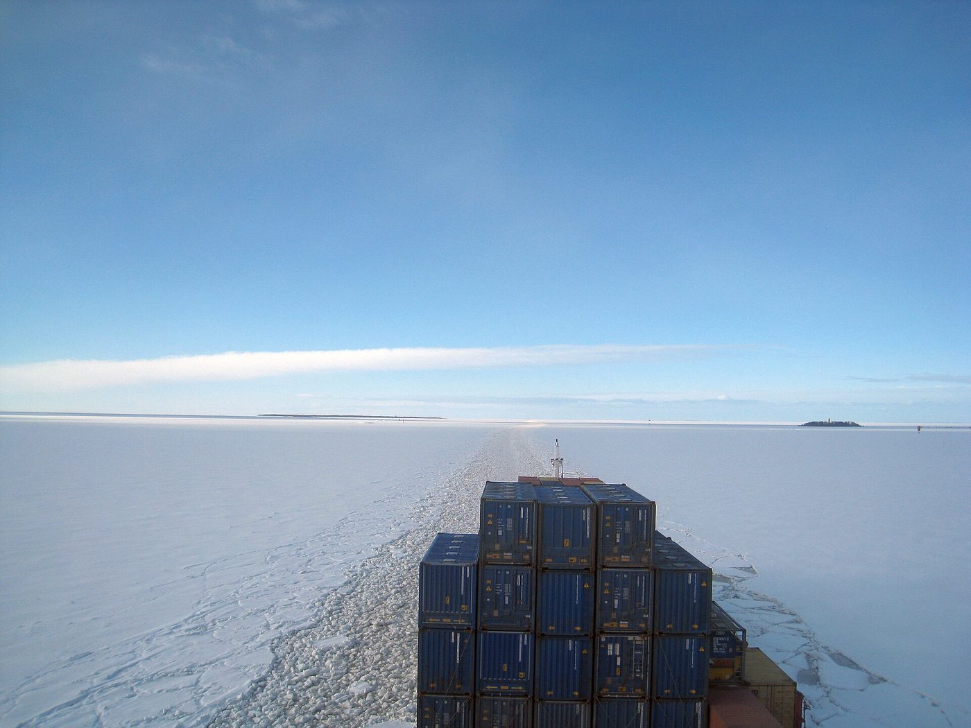 A cargo vessel under way through ice-covered water